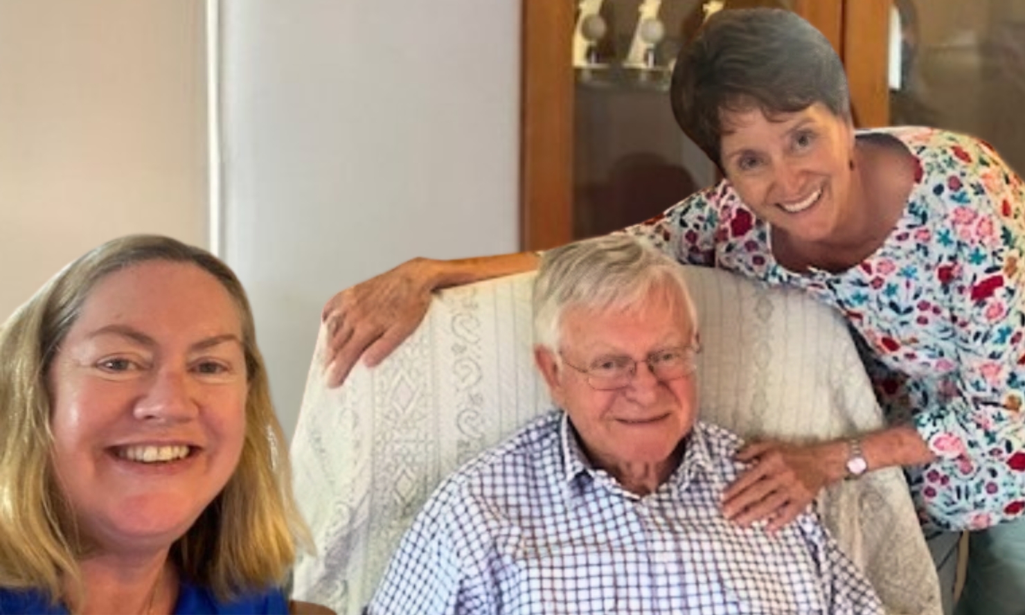 Jane and Errol are smiling warmly for a photo together with one of the BlueCare dementia carers, Helen